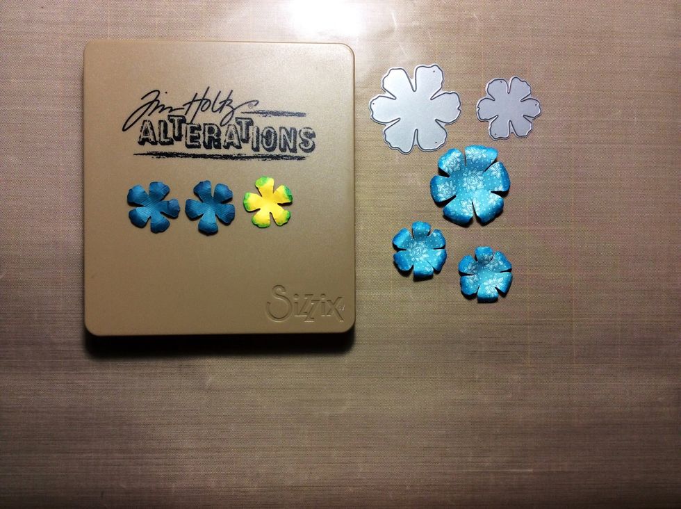 Die cut flowers in 3 sizes from coordinating papers and card stock. Shape and ink. I used distress ink. Mermaid lagoon