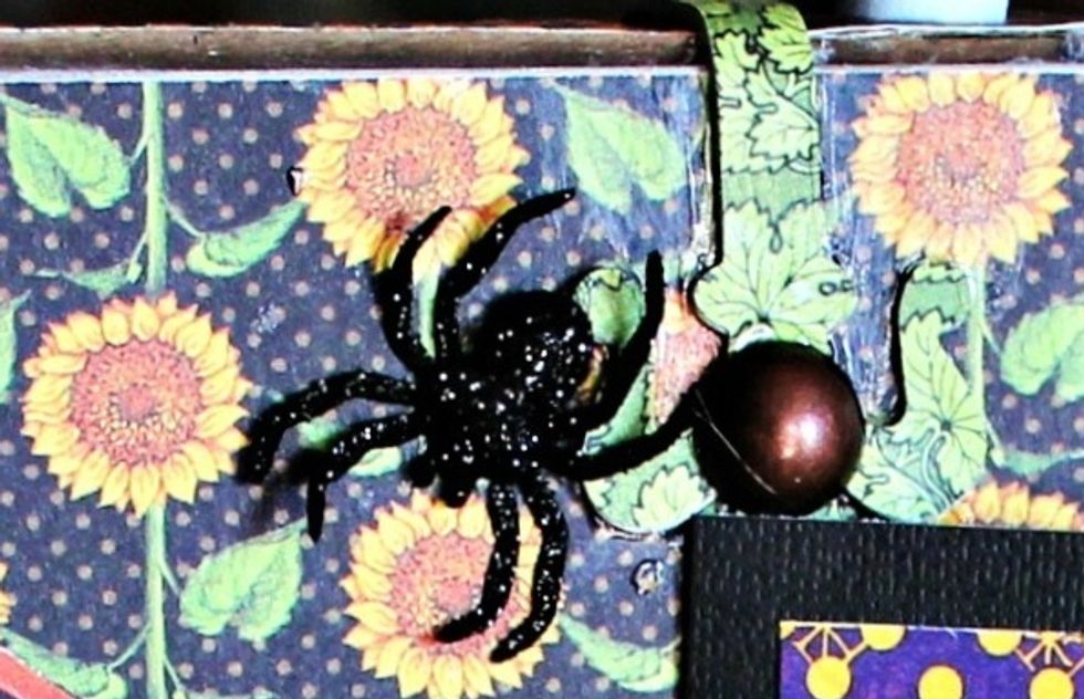 Die cut hardware findings from grunge board and pattern paper. Adhere to prepared lid and stand to form box. Add metal brad and small spider.