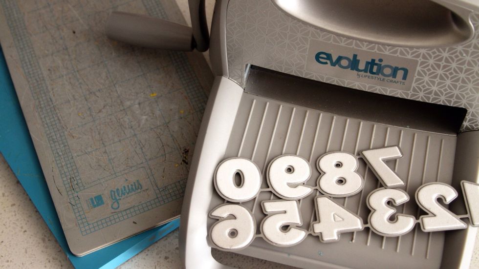 Die cut numbers for the clock face from a thick card stock. I used the Blue Sky alphabet set, Evolution Craft Tool, and Genius platform by Lifestyle Crafts.