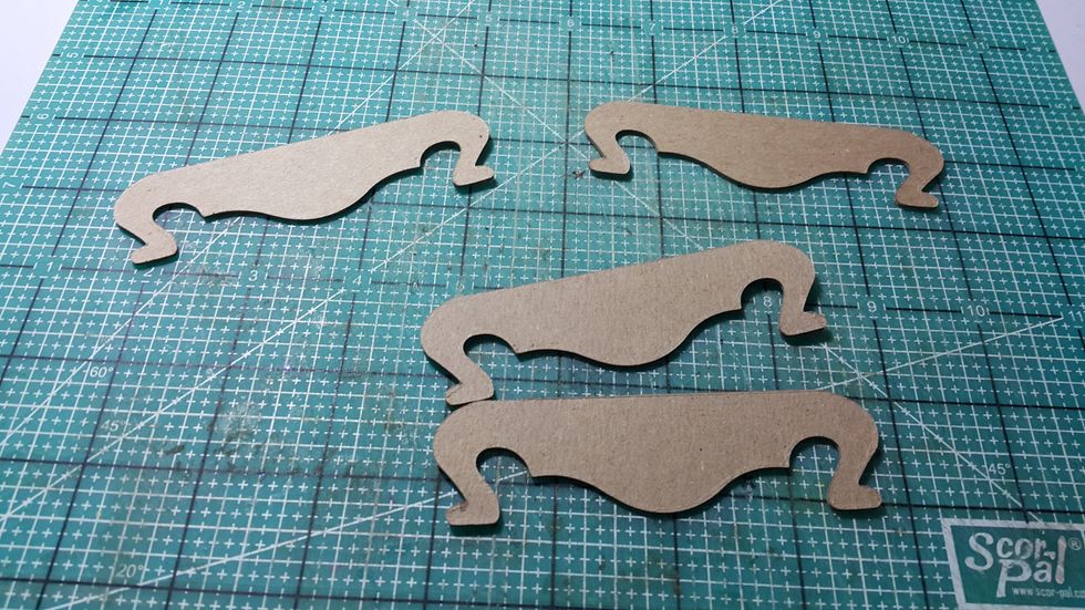 Die cut shapes for dining table feet, double the chipboard to make it stronger.