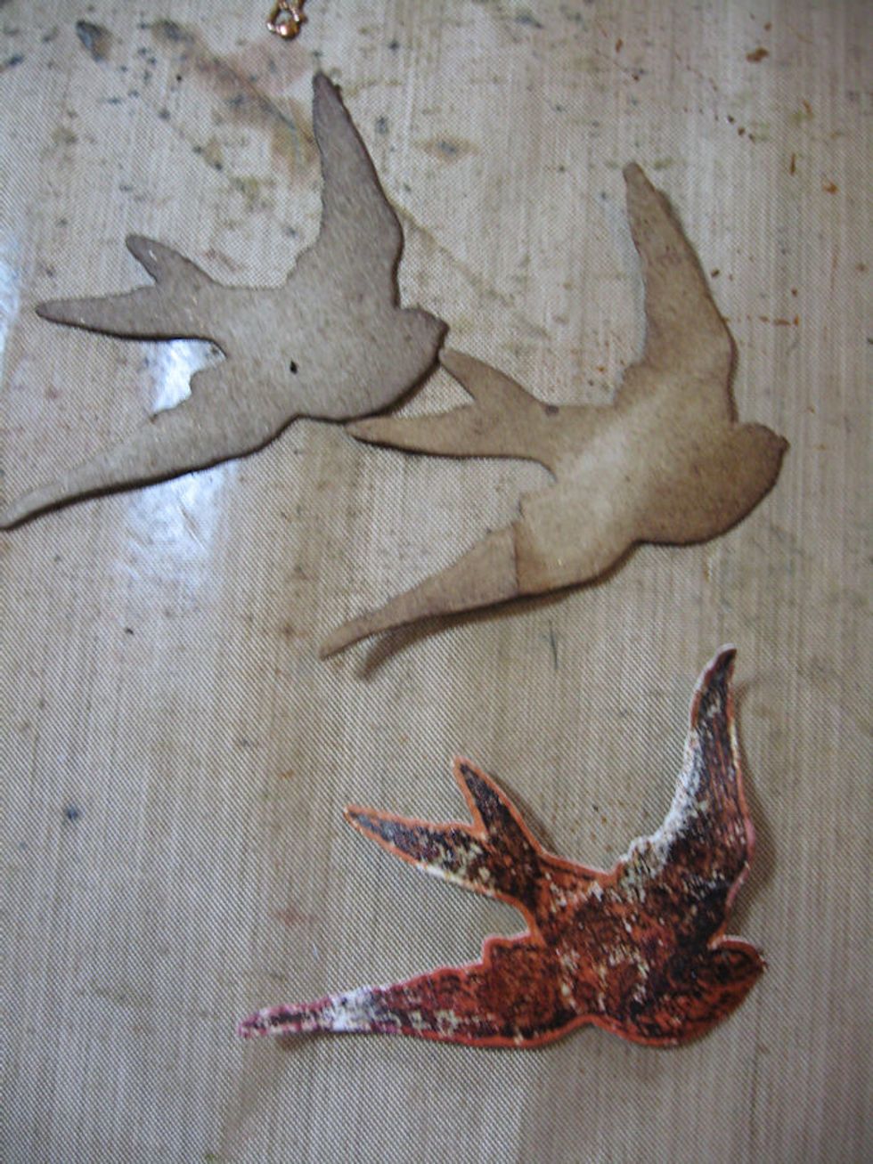 Die cut two more birds from waste chipboard.  Ink with Gathered Twigs.  Use a pencil to shape the wingtips and tail.  Paint the stamped bird with Broken China paint. Glue the three birds together.