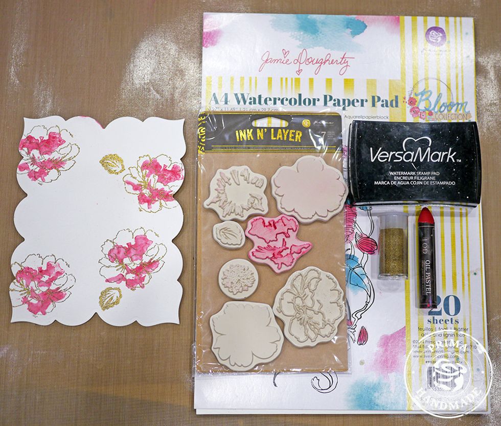 Die-cut watercolor paper using frame die. Apply Red Oil Pastel to solid part of floral stamp, lightly mist with water, stamp. Repeat process until desired look is achieved. Stamp and emboss leaves.