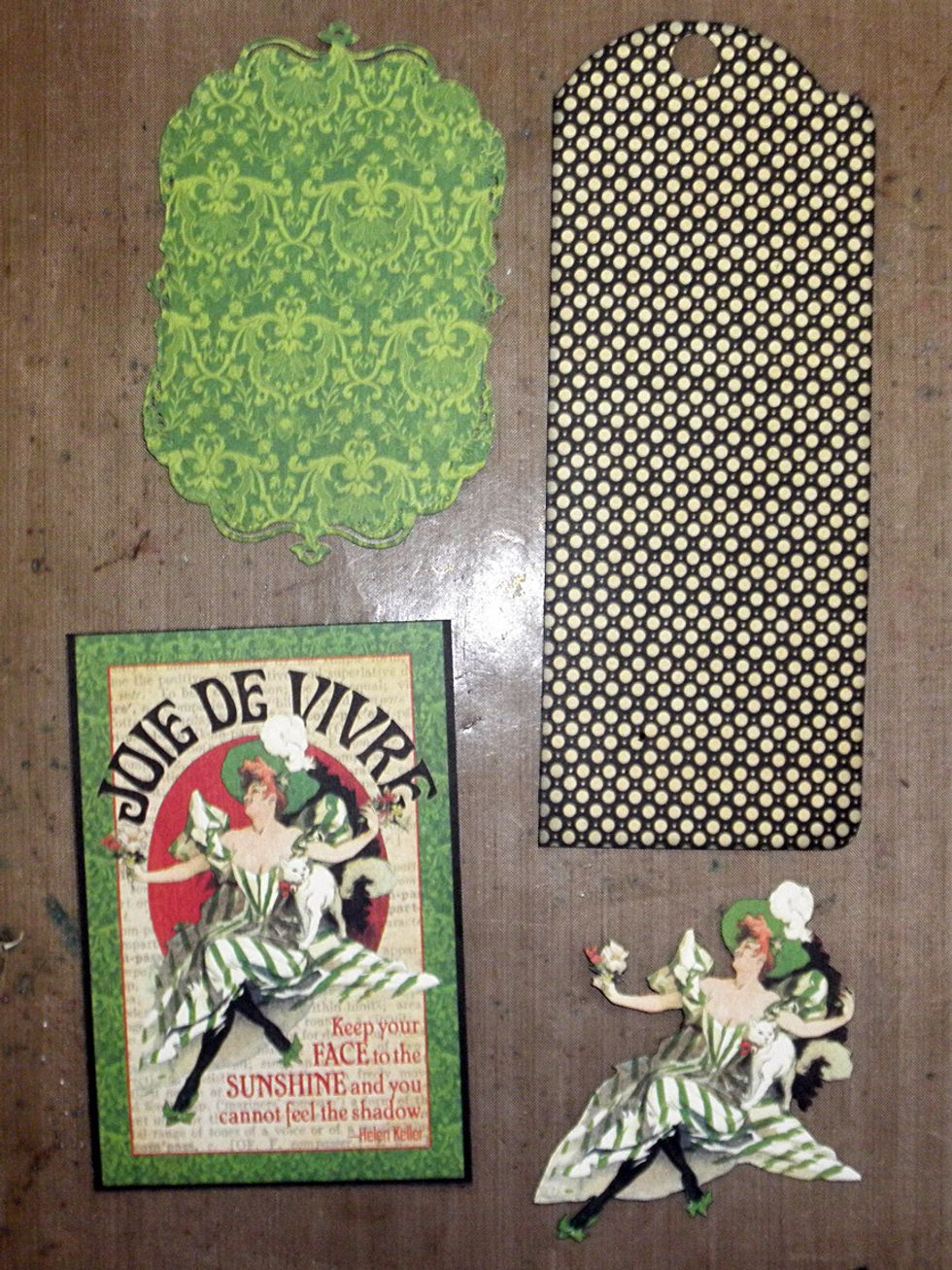 Diecut a frame  from Celebrate w/ the 2nd largest Spellbinders Gold Labels die. Fussy cut the lady from Imagine.  See the next step for cutting the tag.  Ink & distress your pieces as desired.