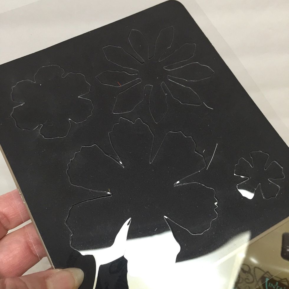 diecut stencil film. you'll want to save both the inner and outer portions of the diecut film as you can use both for positive and negative stenciled images.