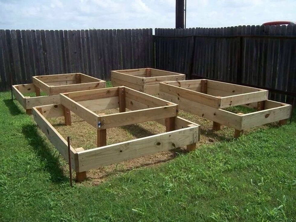 Dig holes for posts and scrape out grass under each box. You may want to add landscaping cloth under each box as well. If you want to link it to your sprinkler system, add it in now.