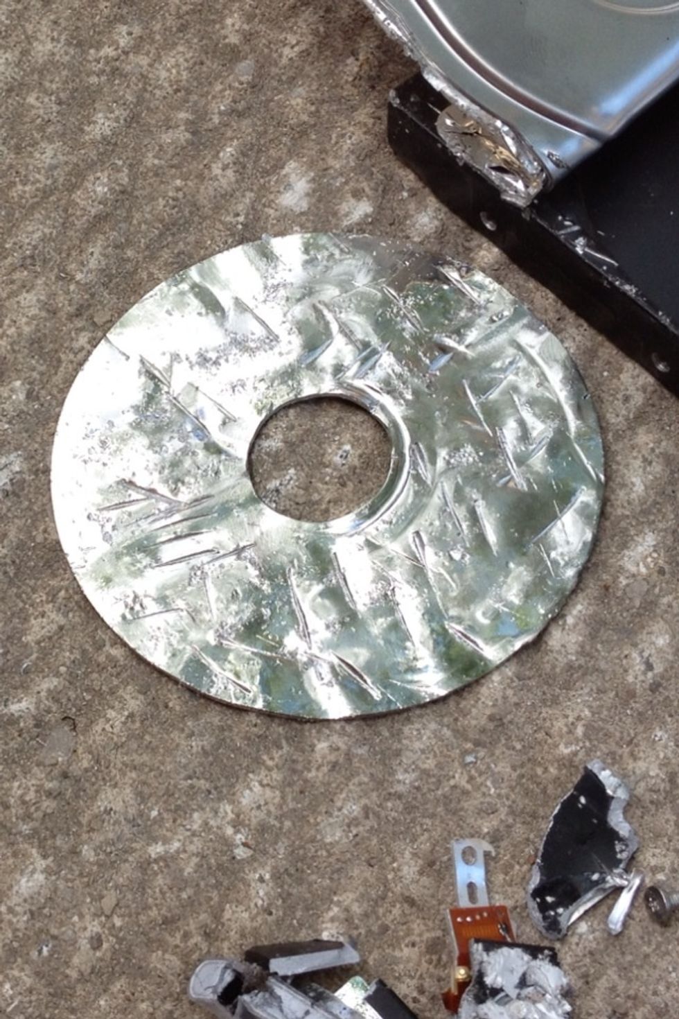 Ding, dent, and scratch this platter. You don't need to swing like an axe murderer, many lighter taps with both the claw and peen of the hammer should destroy the hard drive sufficiently.