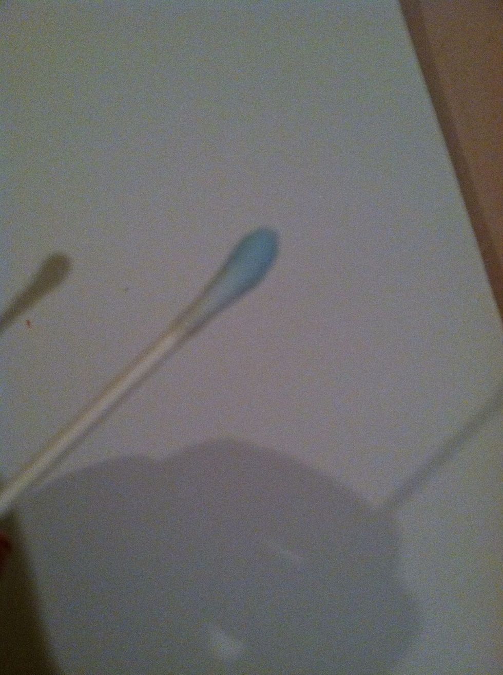 Dip a q-tip into nail polish remover to clean up the edges
