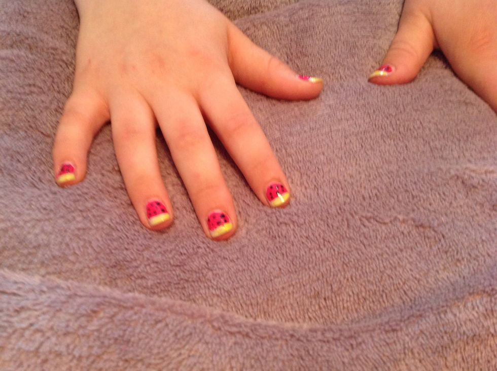 Dip a small dotting pen into your black to create the seeds on the pink