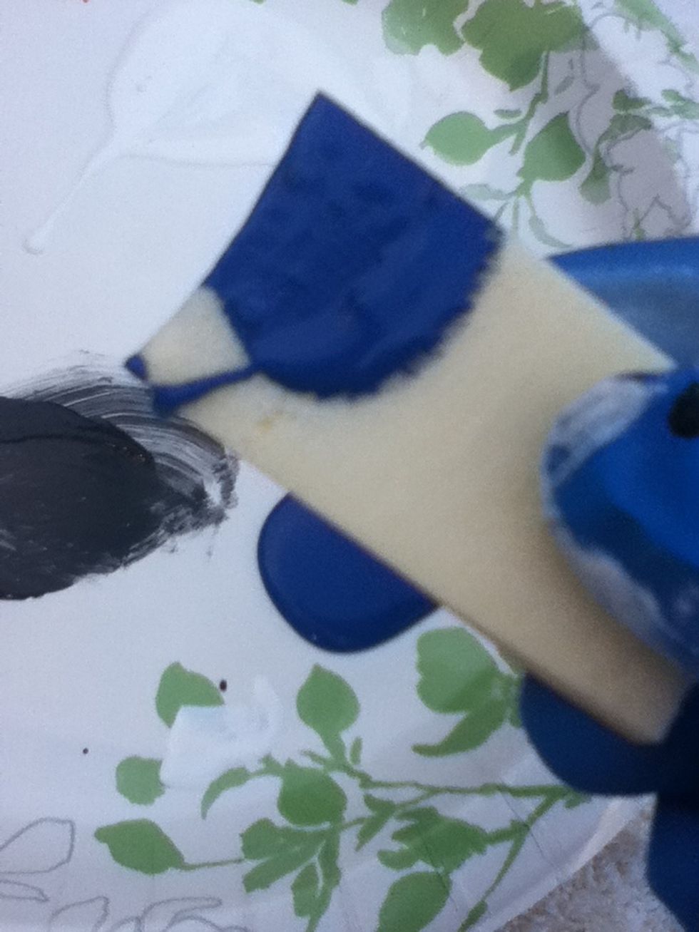 Dip a sponge into blue paint.