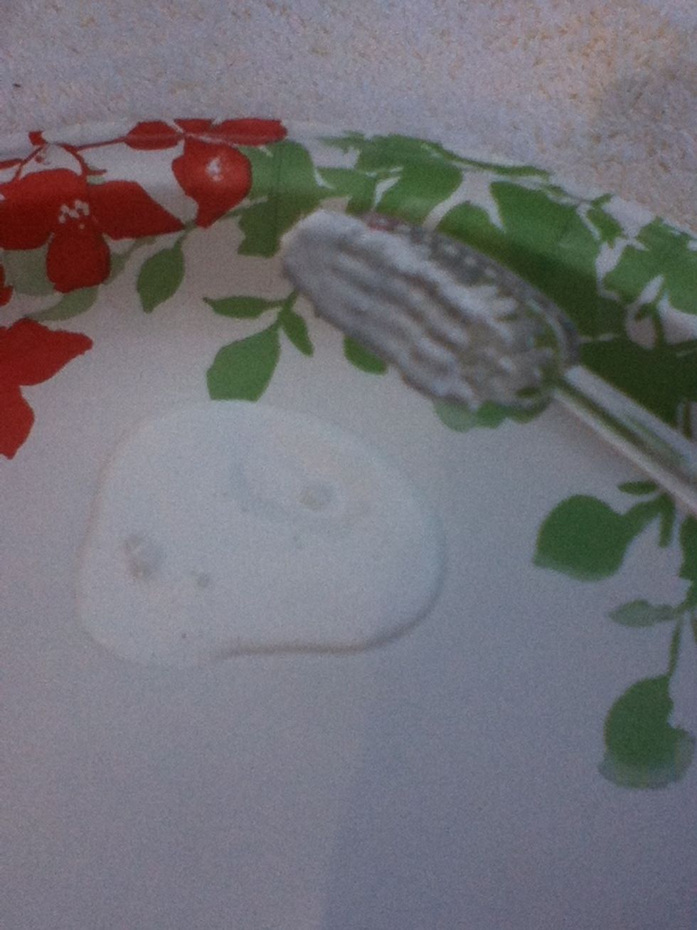 Dip a toothbrush in white paint.