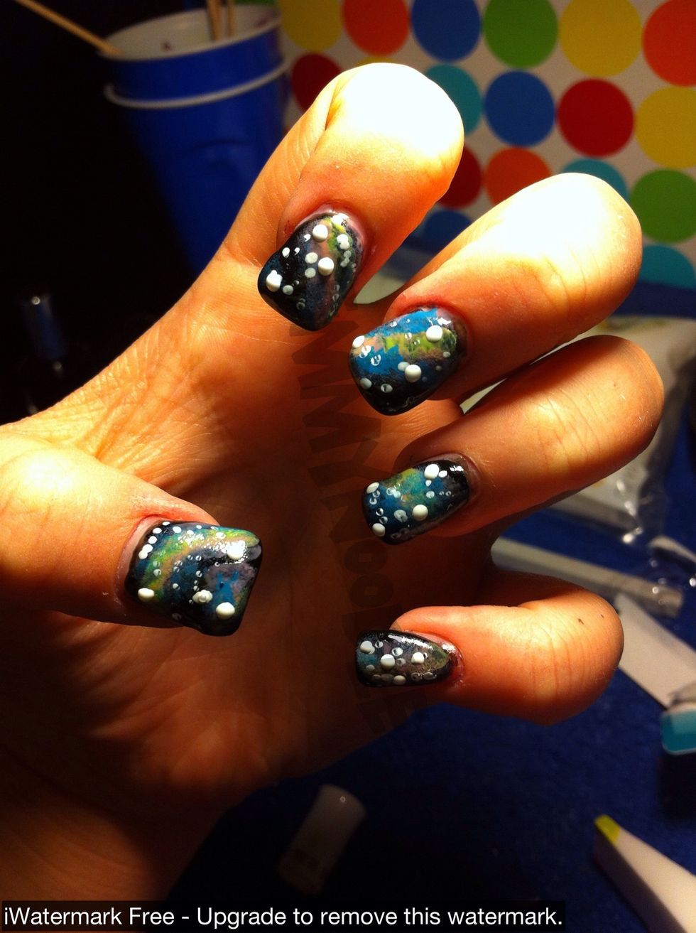 Dip a toothpick into white polish and make random dots to make your stars. Make them vary in size.