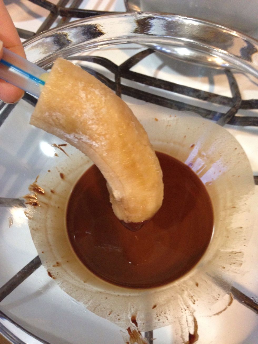 Dip and coat the banana in the chocolate