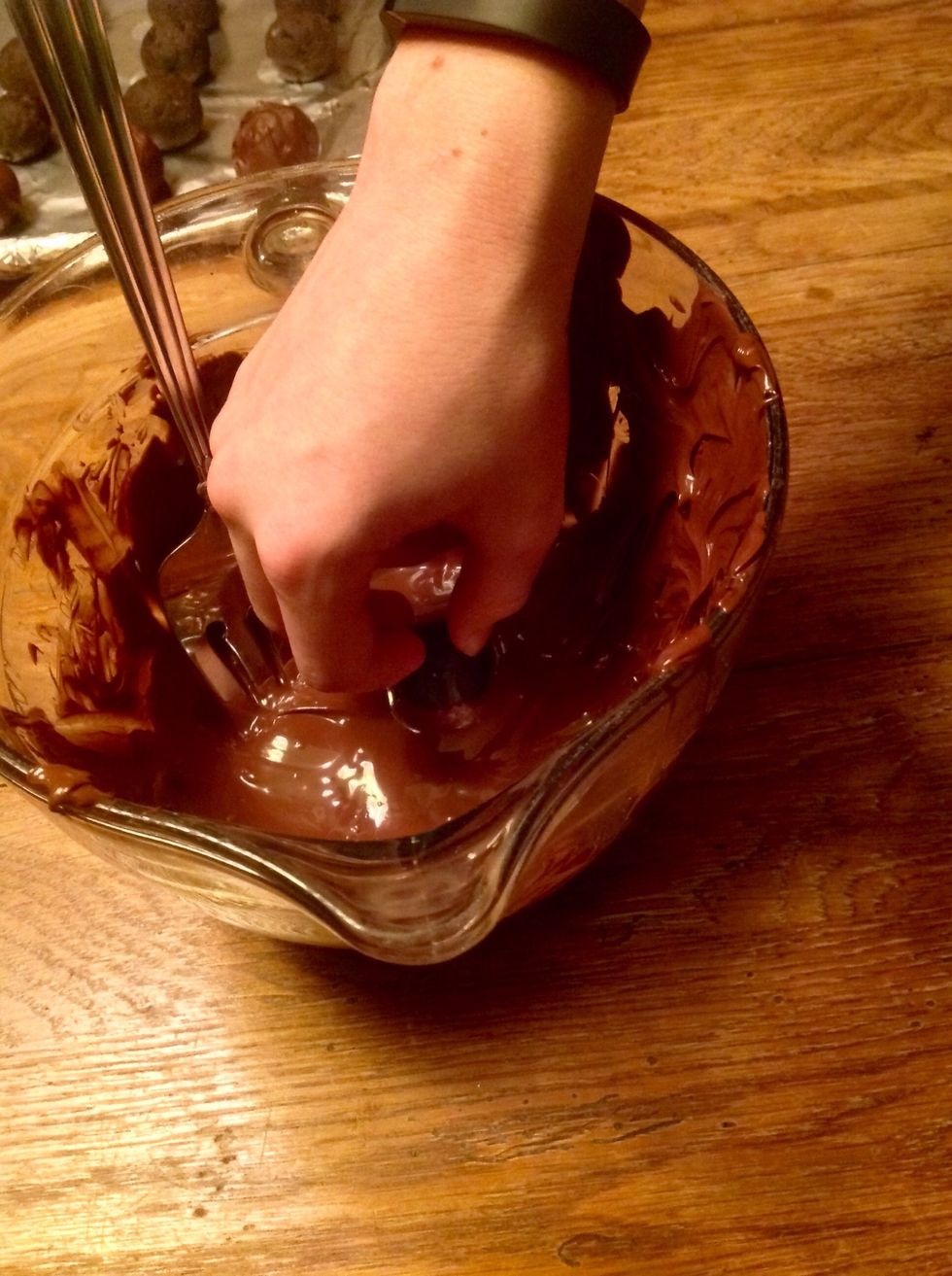 Dip balls in chocolate until completely covered and then place back on foil.