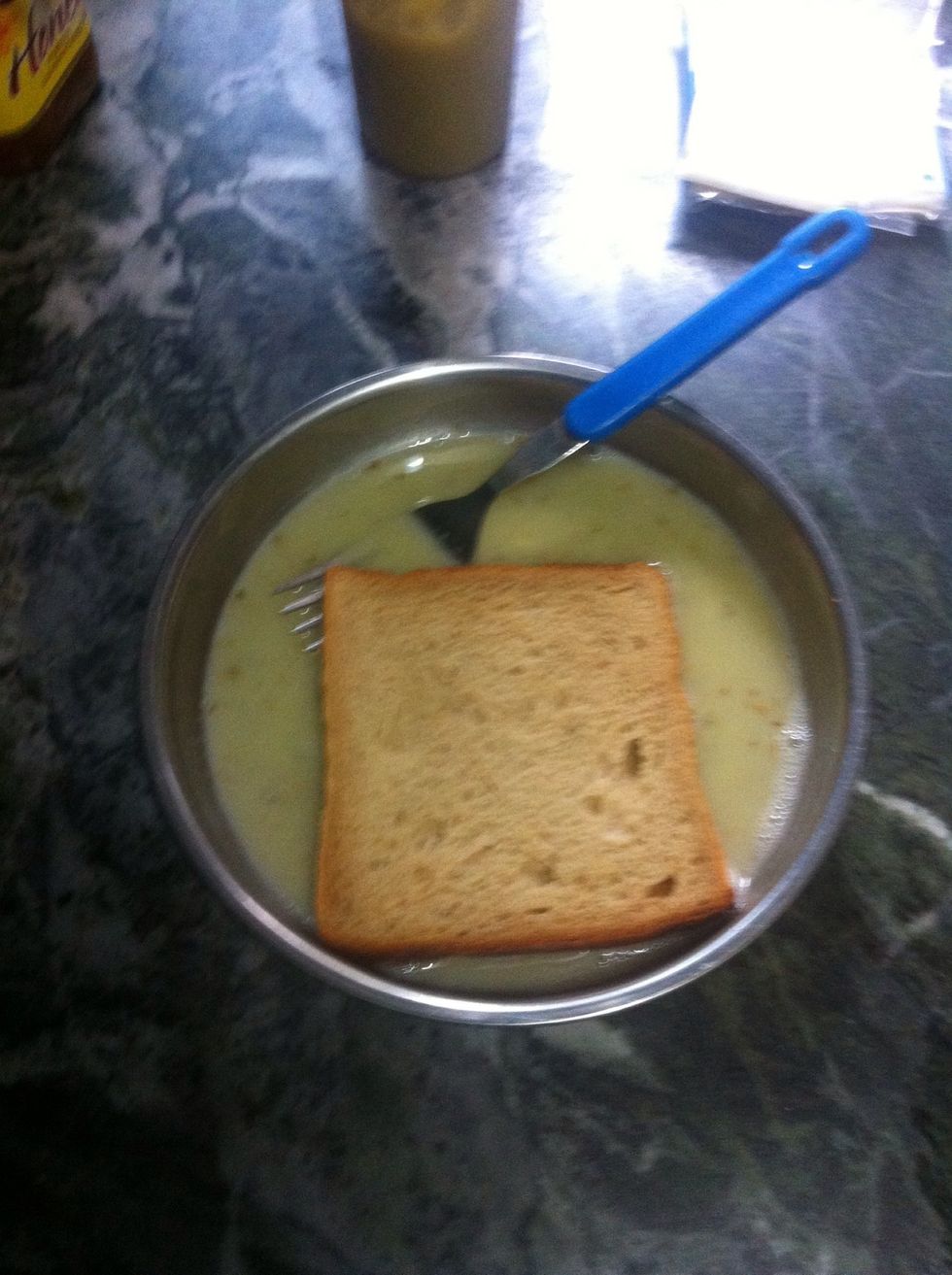 Dip both the sides of a slice of bread