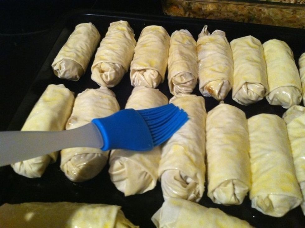 Dip brush in melted butter mixture, and coat the tops of your rolls. Cook in oven for 30 min @ 325 degrees. Remove, re-glaze with butter, turn temp to 375, and cook for 15 min or until golden brown.