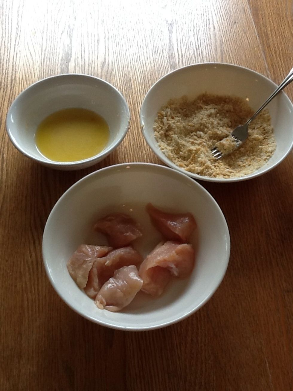 Dip chicken in butter, then cornflake mixture. Coat well and place in a greased 13x9 baking dish.