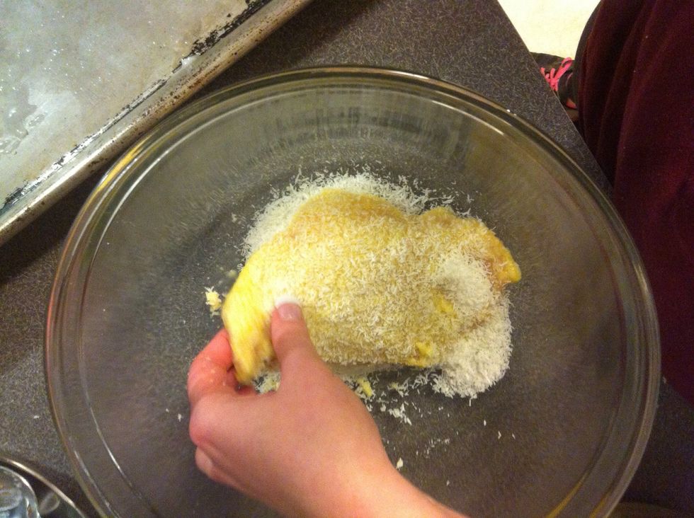Dip chicken in shredded coconut covering both sides