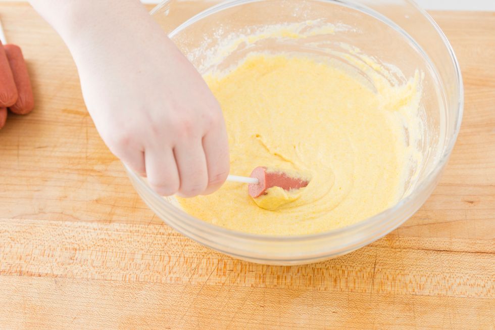 Dip each hot dog in the batter until it's completely coated.