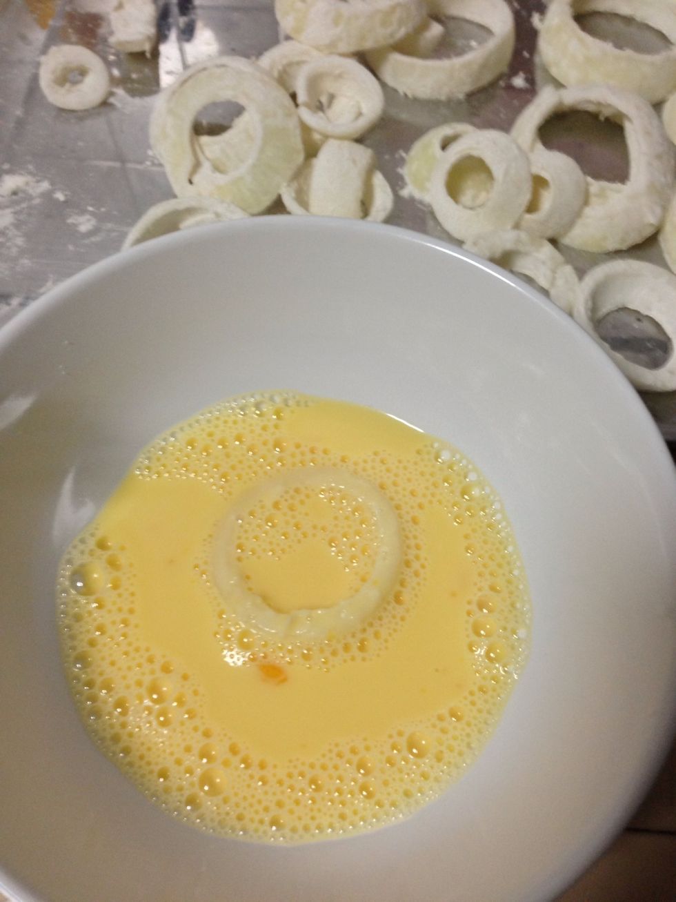 Dip each onion ring to the egg and milk mixture.