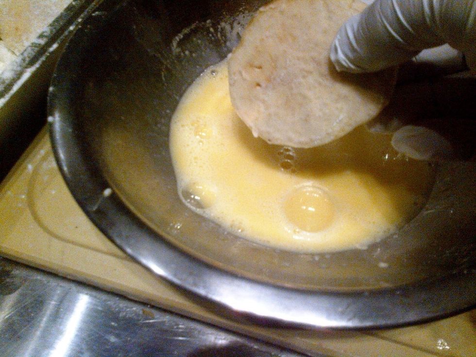Dip eggplant into the flour, then into the egg until fully covered.