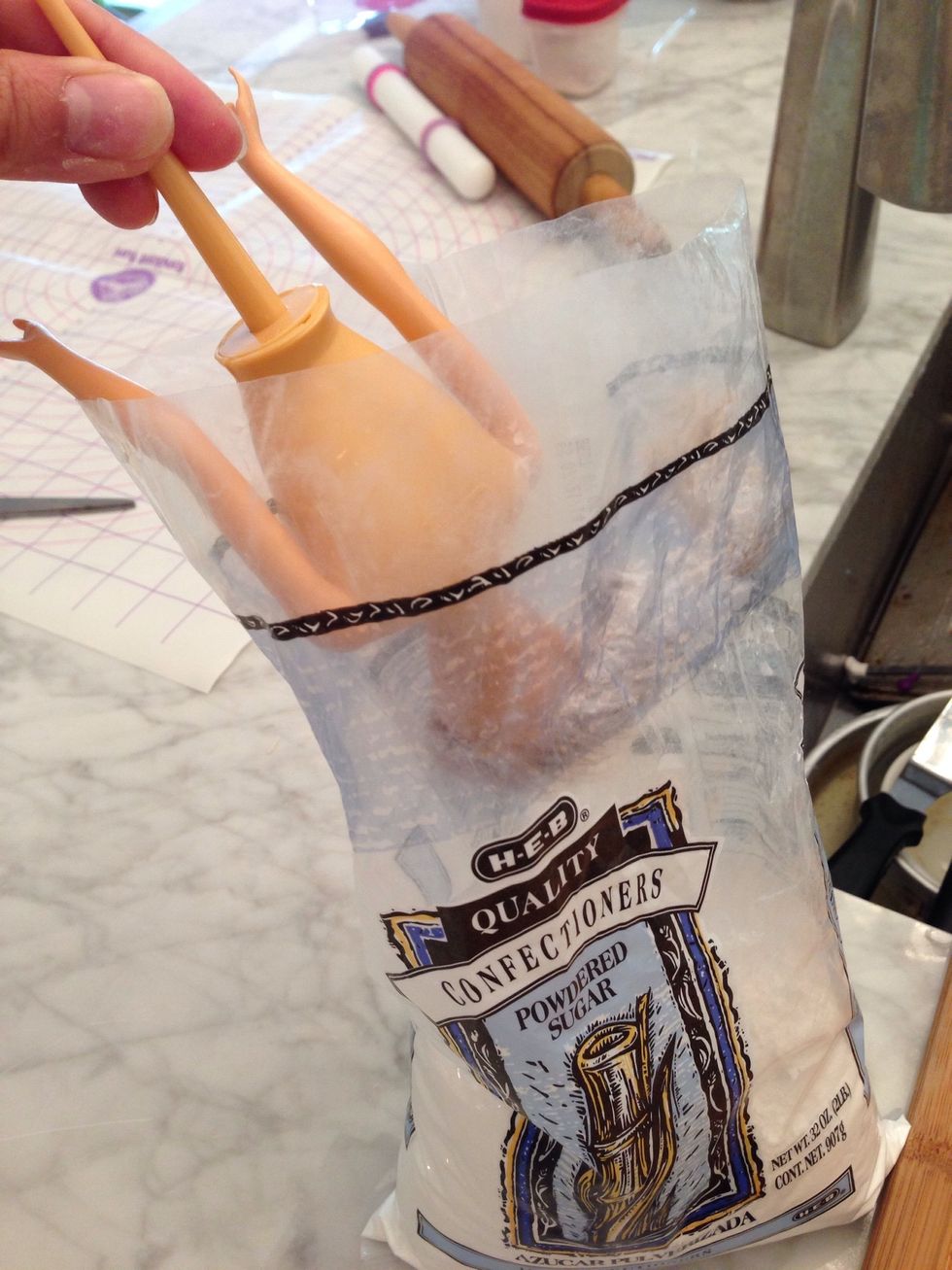 Dip Elsa head in power sugar to make her hair white