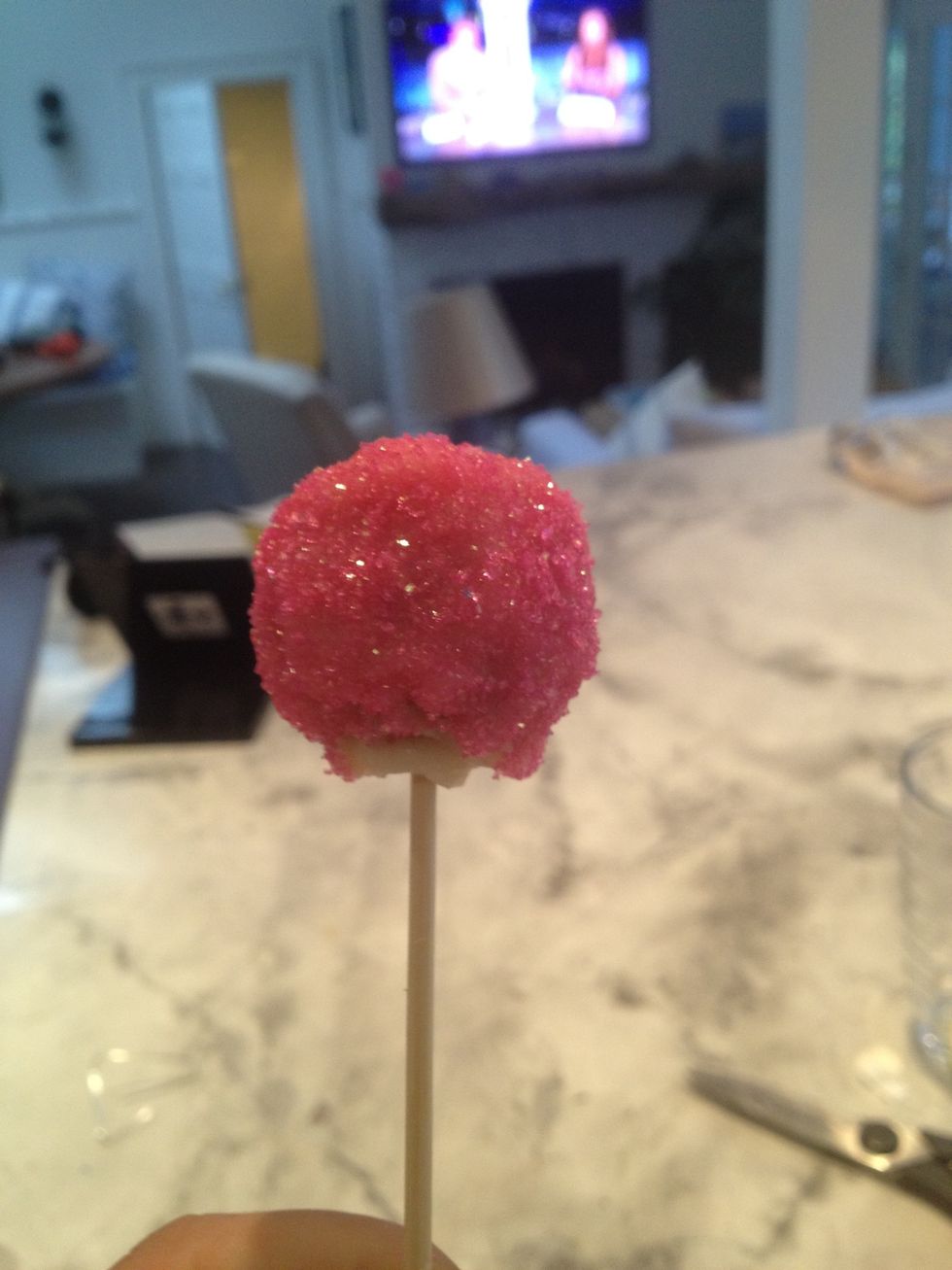 Dip horizontally the cake ball on the stick in the chocolate, be careful the cake ball doesn't fall off