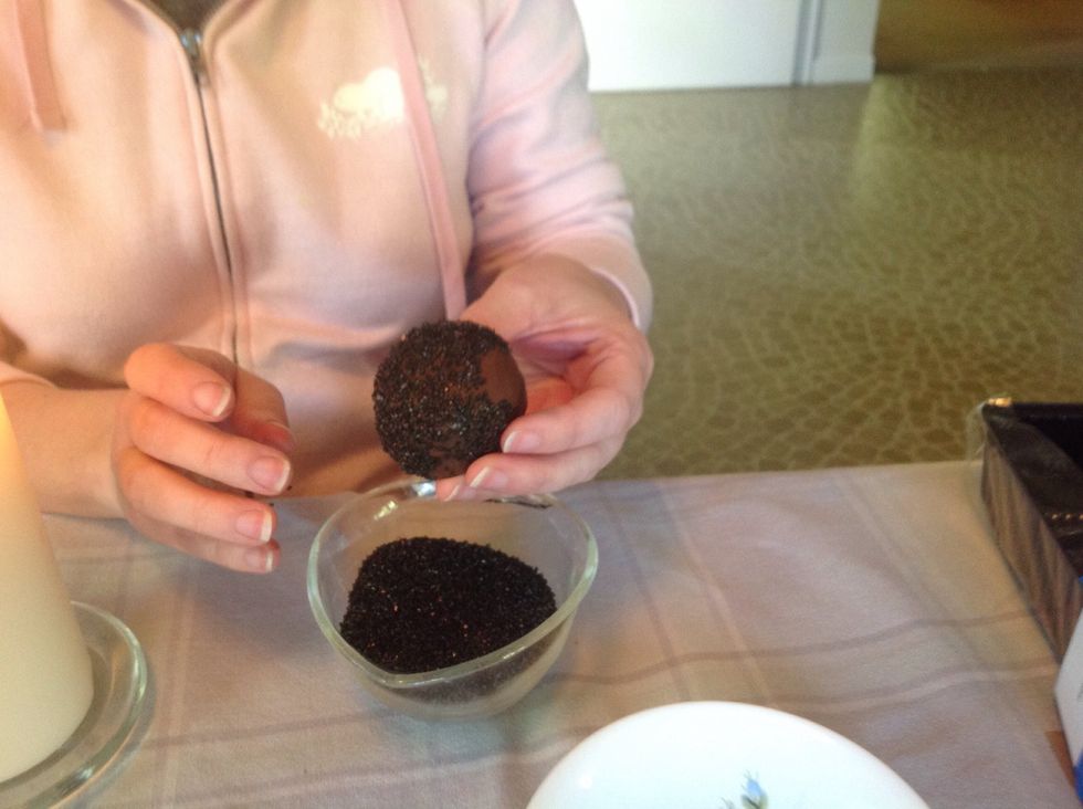 Dip in black sprinkles or black sugar (shown here)... Whatever you can find in the cake decorating section.