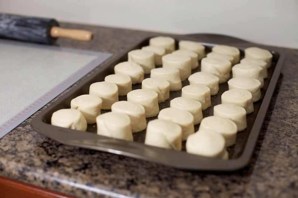 Dip one cut end of each piece in the cornmeal.  Arrange the pieces in a 4x4 grid on one half of the cookie sheet, cornmeal side down.  Repeat with the other half of the dough to make a 4x8 grid.