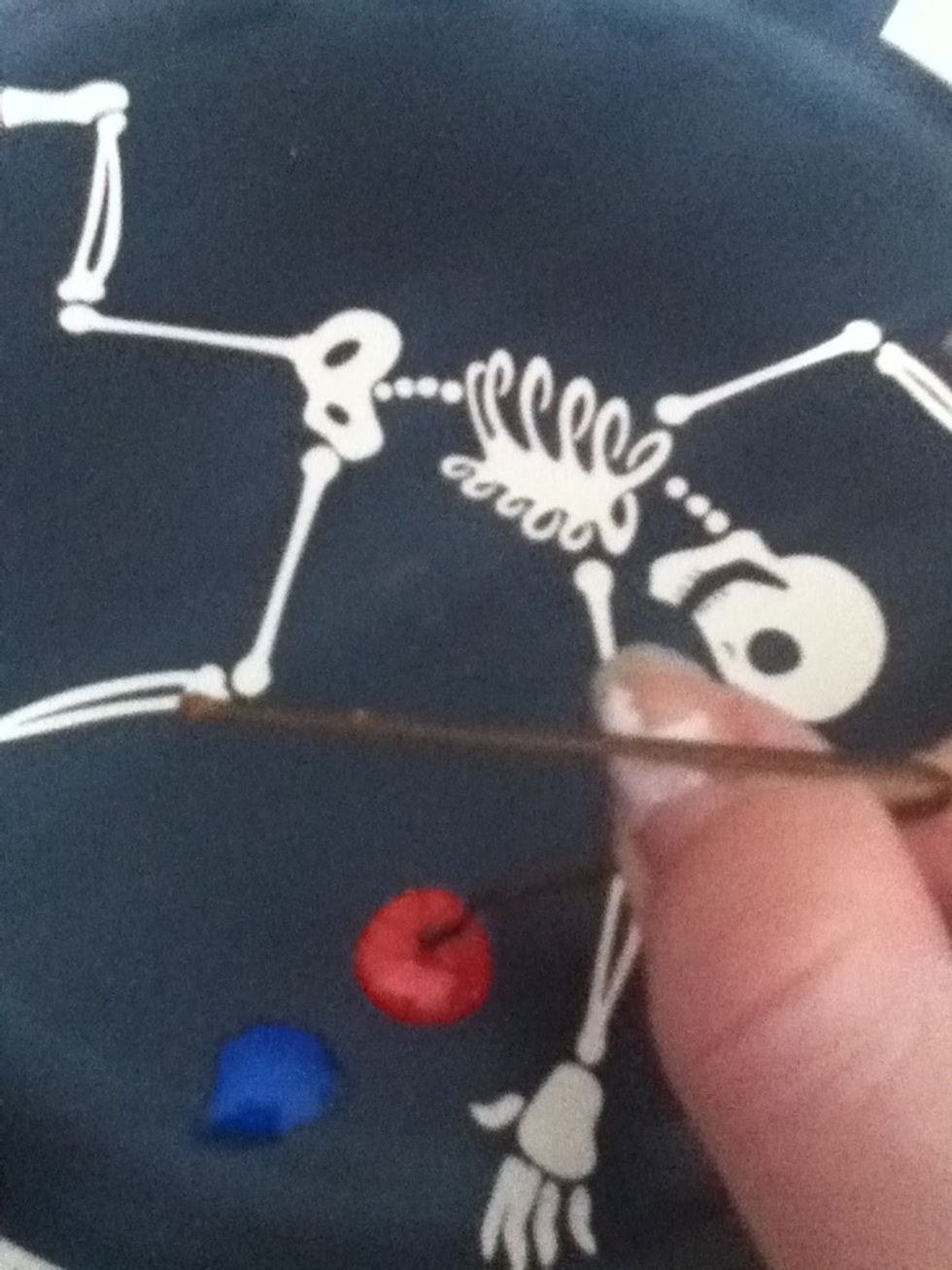 Dip one end of bobby pin into orange nail polish.