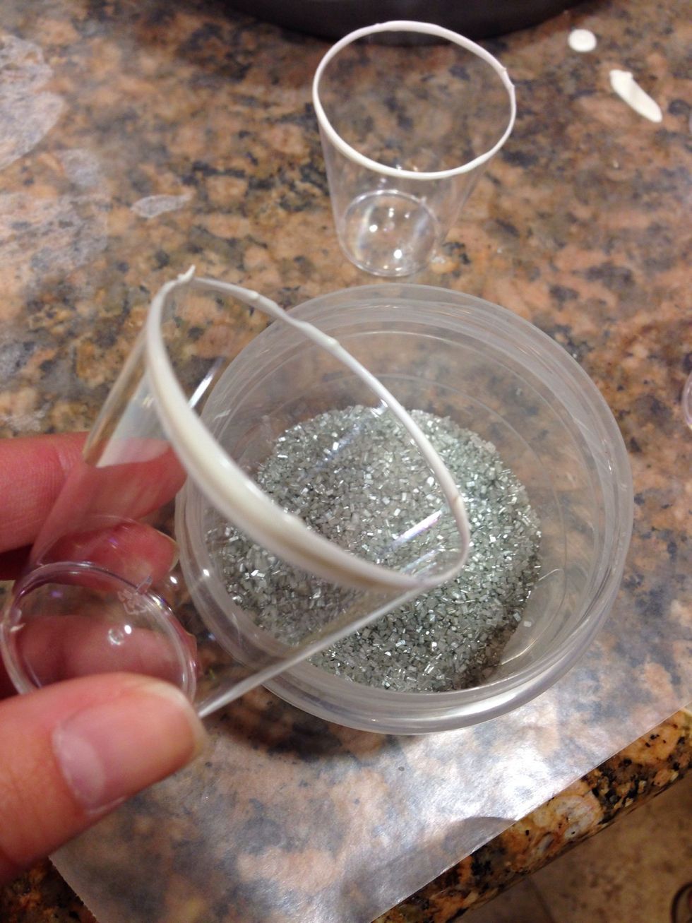 Dip rim of shot glass into the melted chocolate and immediately into sprinkles. Thinner layer of chocolate, the better (believe me) the chocolate and sprinkles will run down the glass.