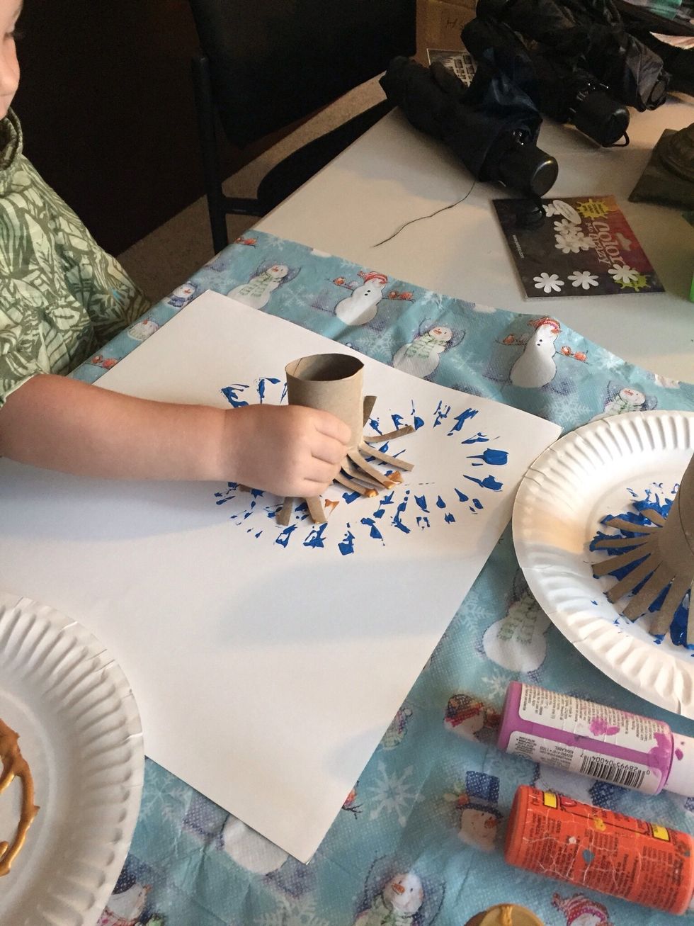 Dip roll in paint and press down on paper, repeat