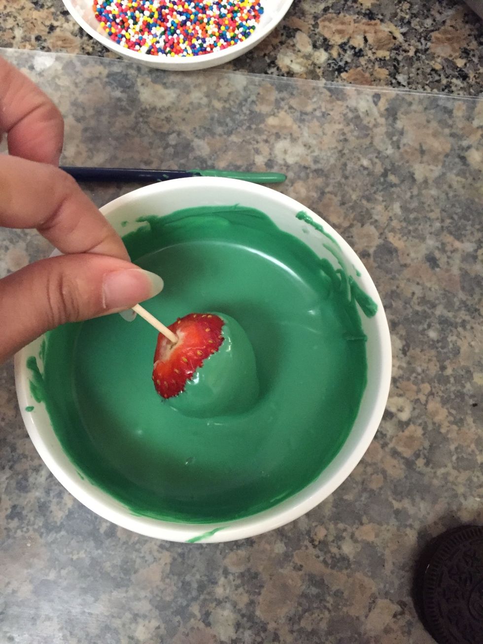 Dip strawberry into the melted chocolate