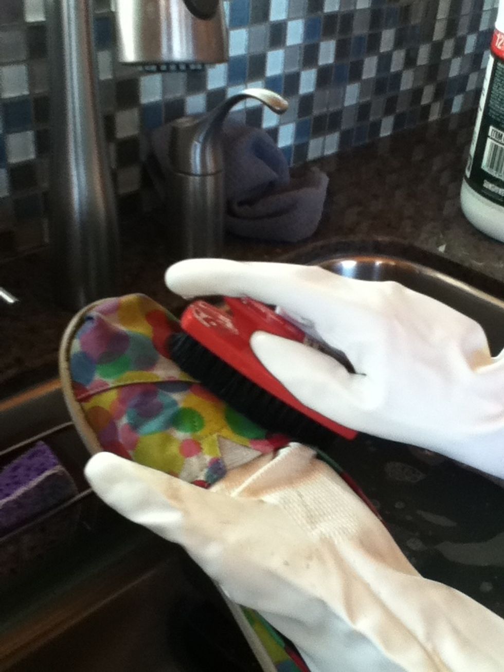 Dip the brush in the solution and brush the shoe briskly, keep dipping and brushing until the shoe look shiny and new