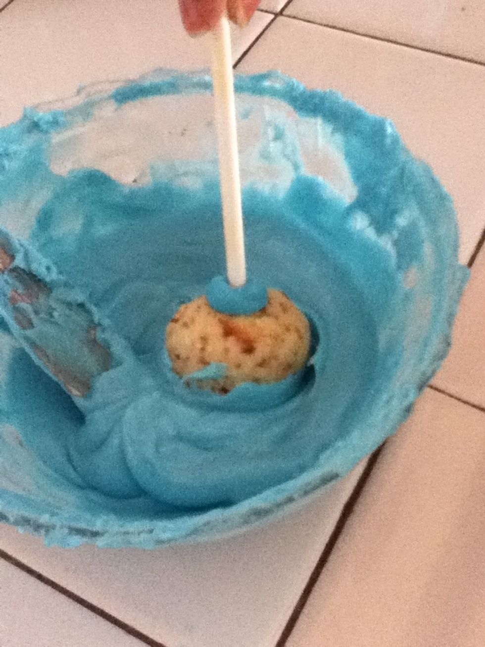 Dip the cake pop in melted chocolate