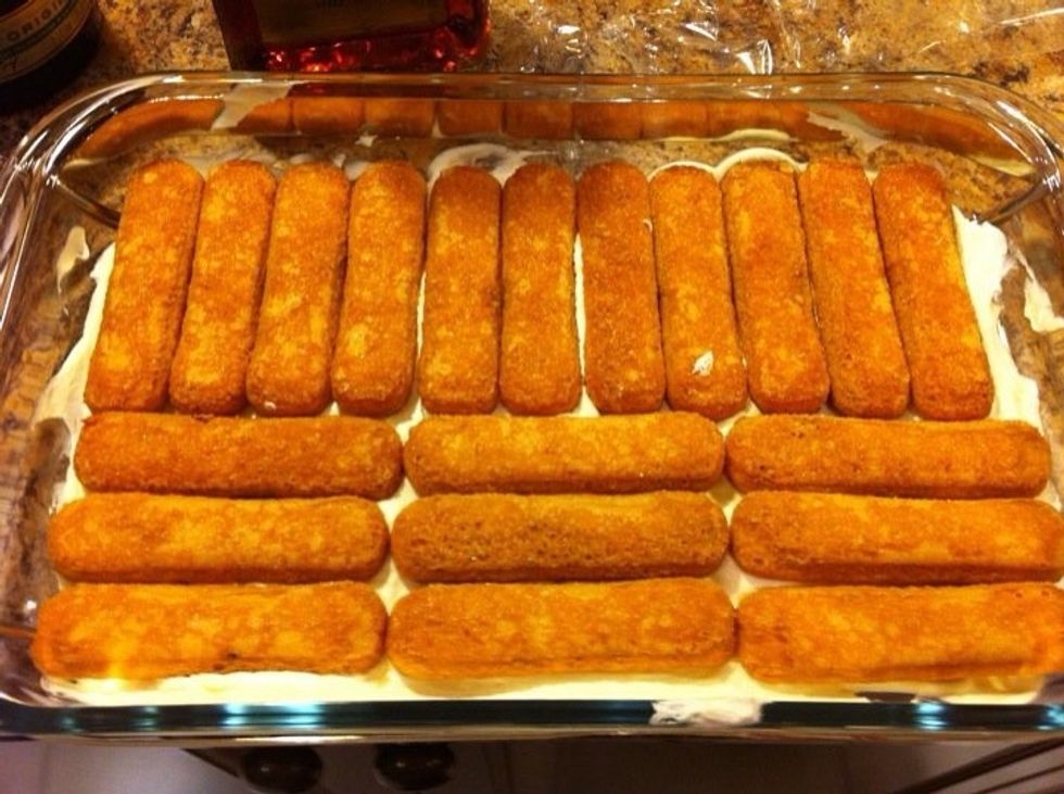 Dip the cookies lightly in the coffee mixture and place them in the dish.