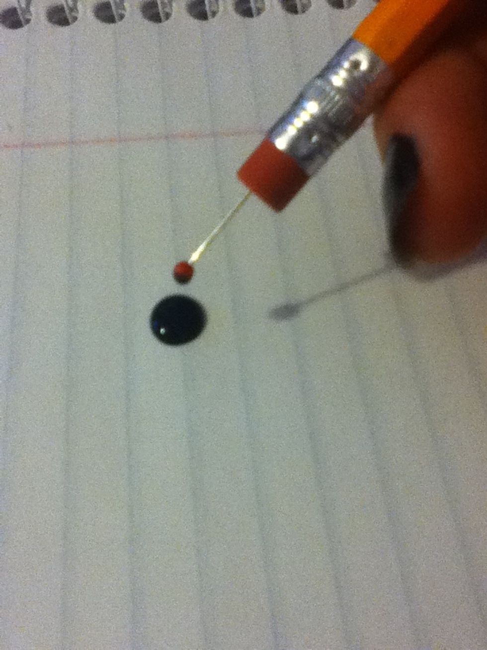 Dip the dotting tool into the polish and then onto your nails to create polka dots.
