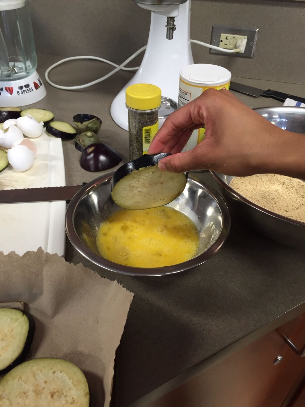 Dip the eggplant into the egg mixture and then the breadcrumbs one at a time