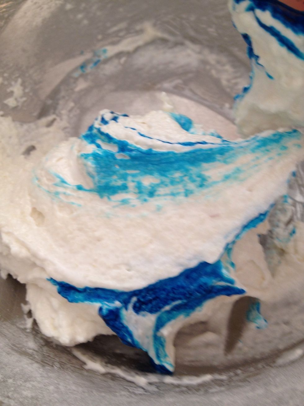Dip the end of the spatula in the food colouring and continue folding the mixture. Repeat this until desired colour is achieved.
