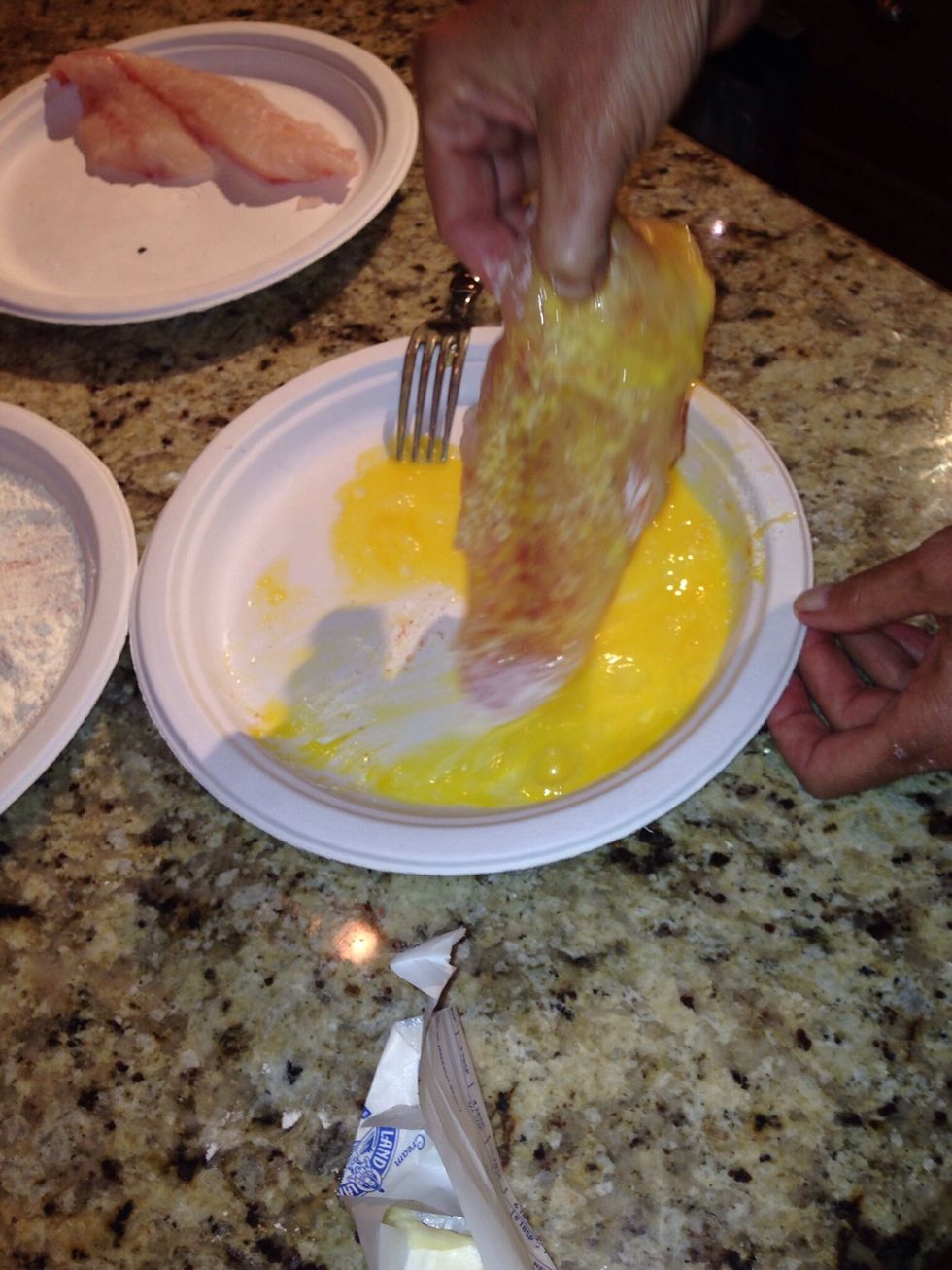 Dip the fillets in the beaten egg.
