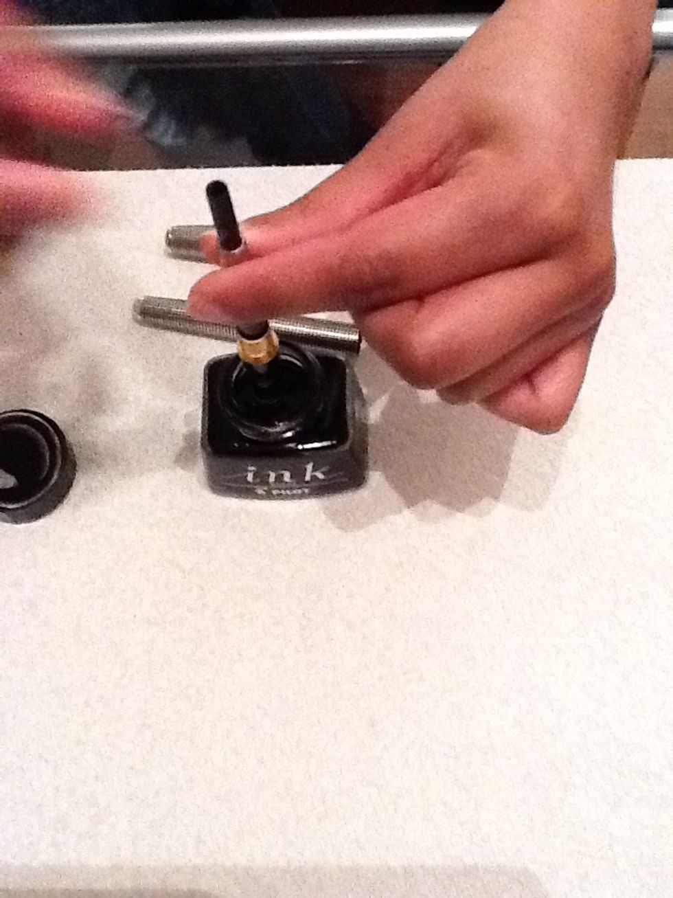 Dip the nib into the inkwell, it should be fully immersed.