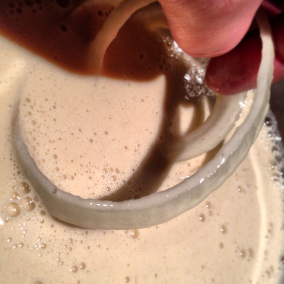 Dip the rings into the batter and cover.