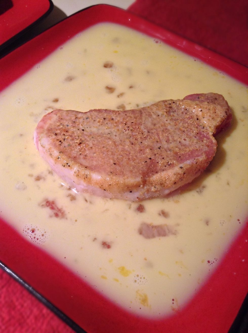 Dip the seasoned pork chops into the egg wash then carefully place in the bread crumbs.