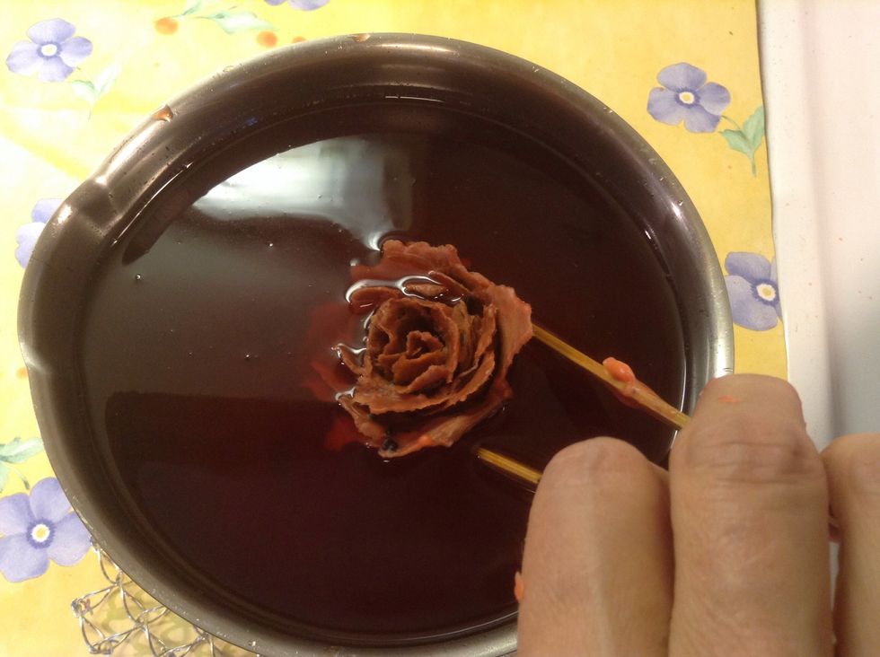 Dip the settled rose again into the candle wax. Dip each rose into wax at least three times.
