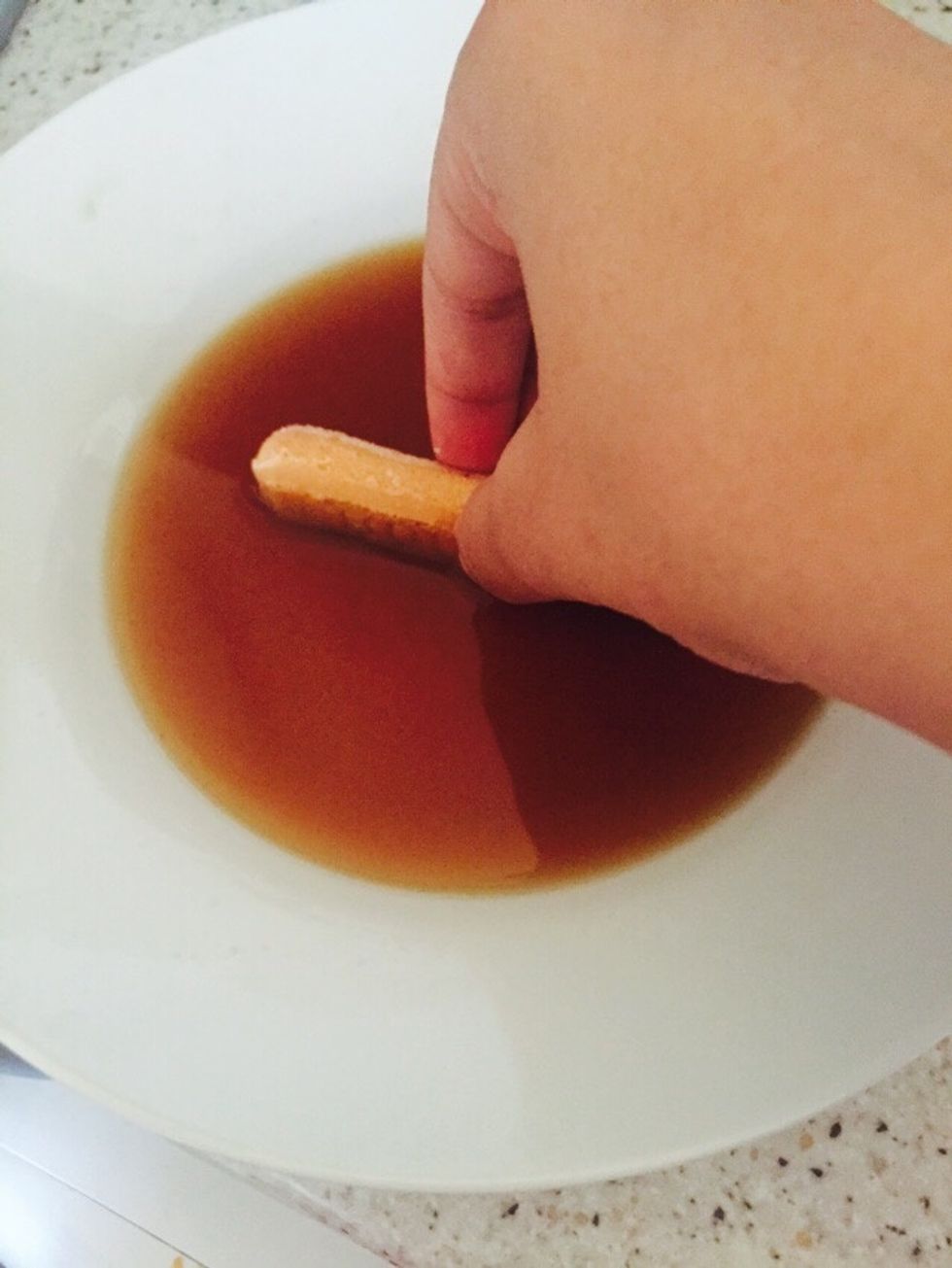 Dip the sponge finger in warm coffee and layer it out.