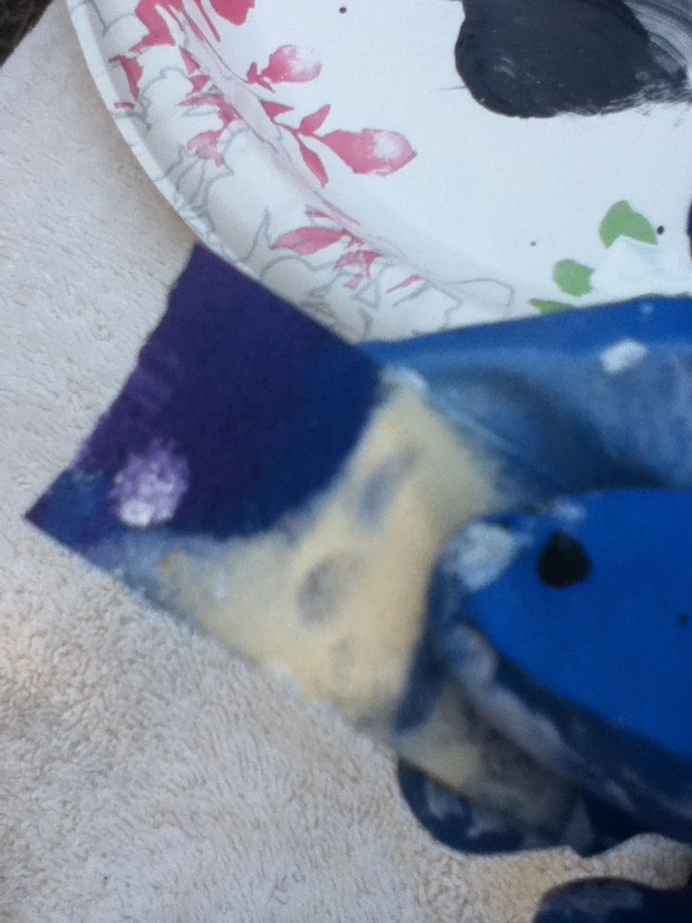 Dip the sponge in purple paint.