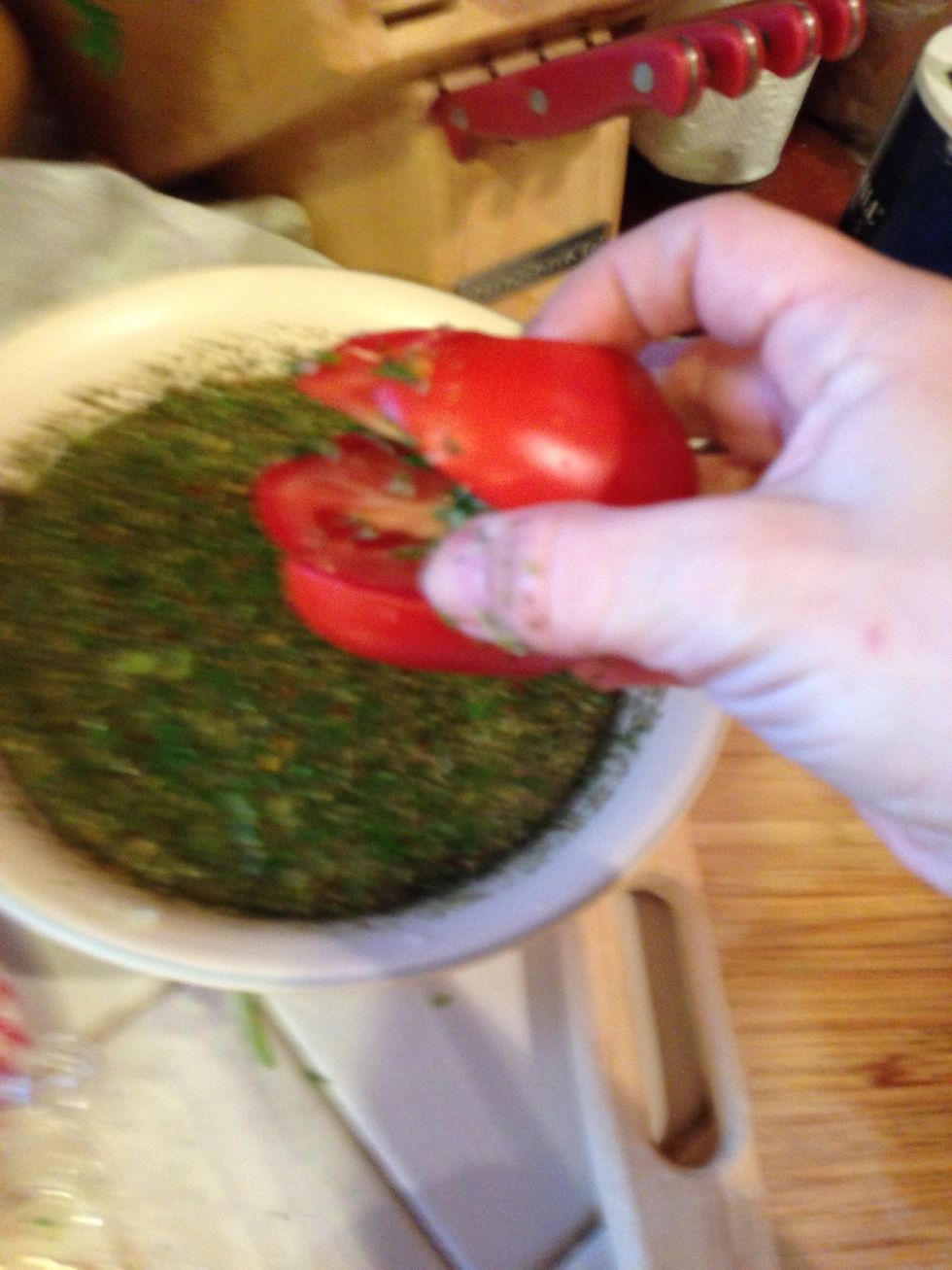 Dip the tomatoes in the marinade scooping the solids