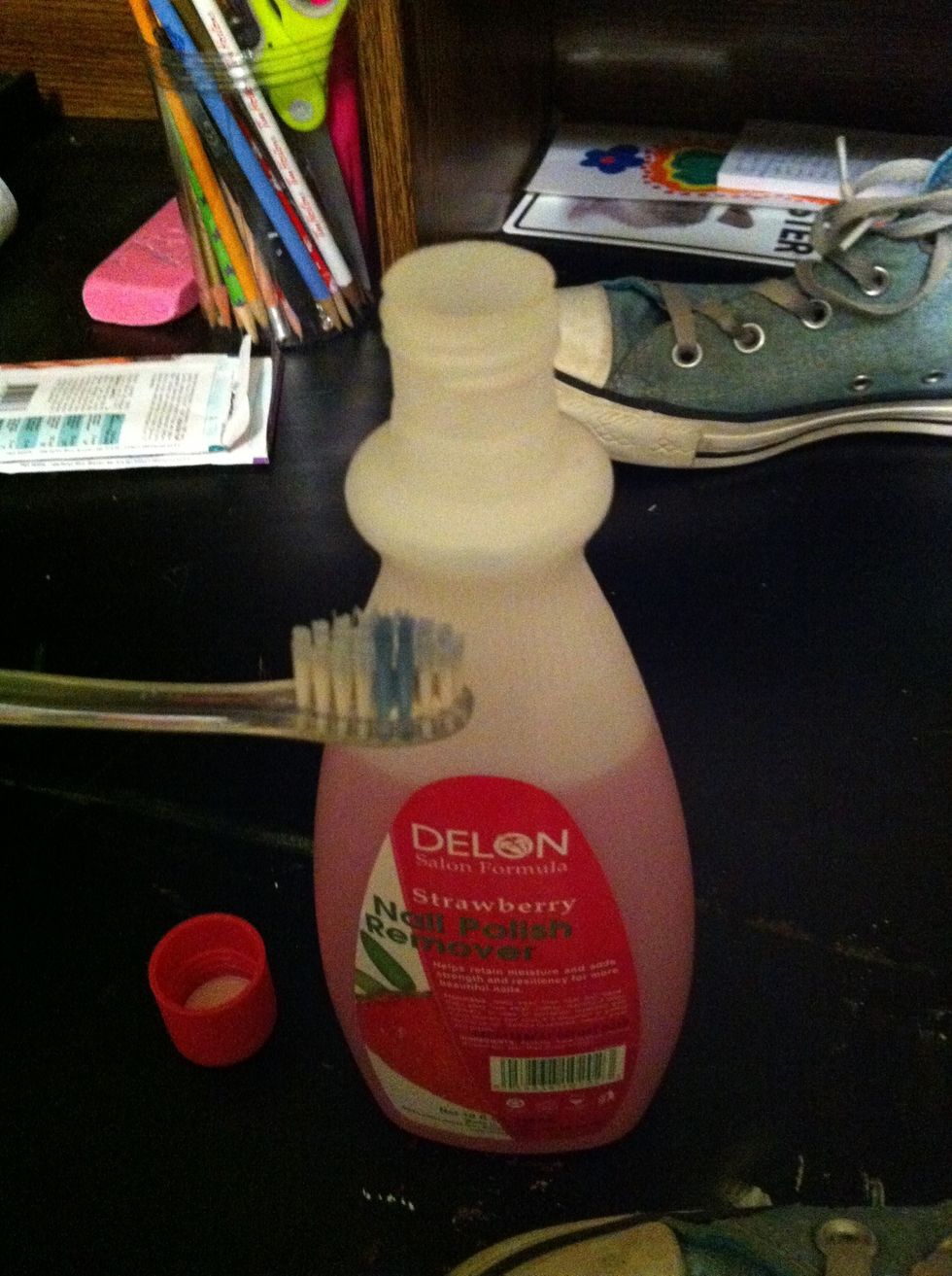 Dip the toothbrush (that you never want to use again) into the nail polish remover.