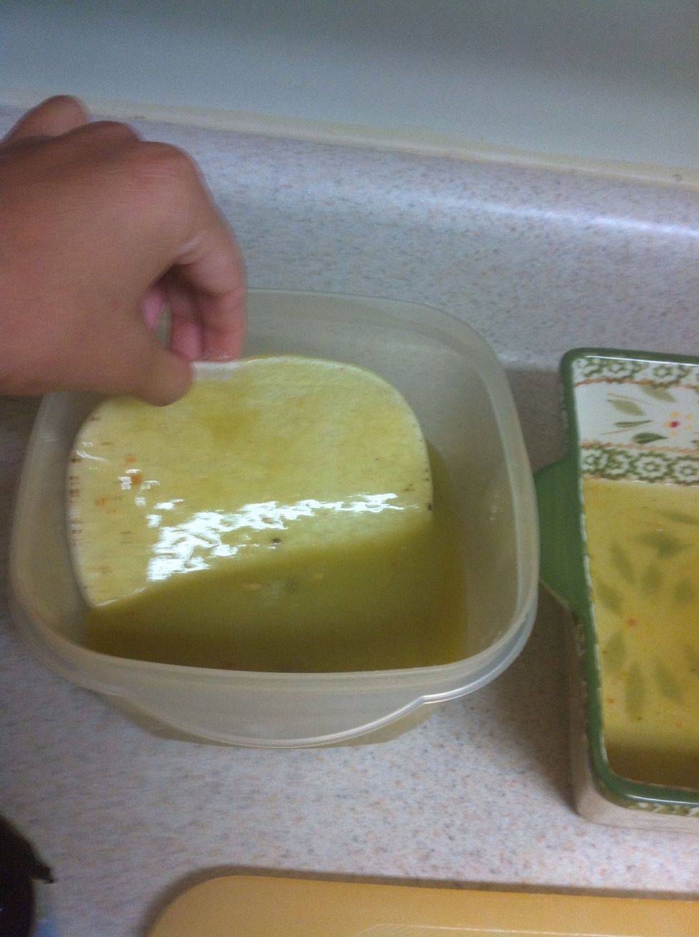 Dip tortillas in sauce and layer on the bottom of the pan so it's covered