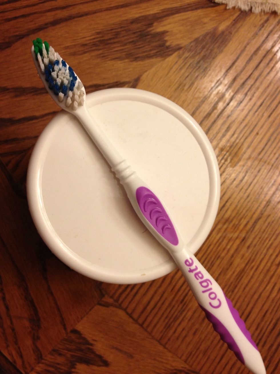 Dip wet toothbrush in tooth powder and a small amount will stick to the toothbrush. Brush as usual.