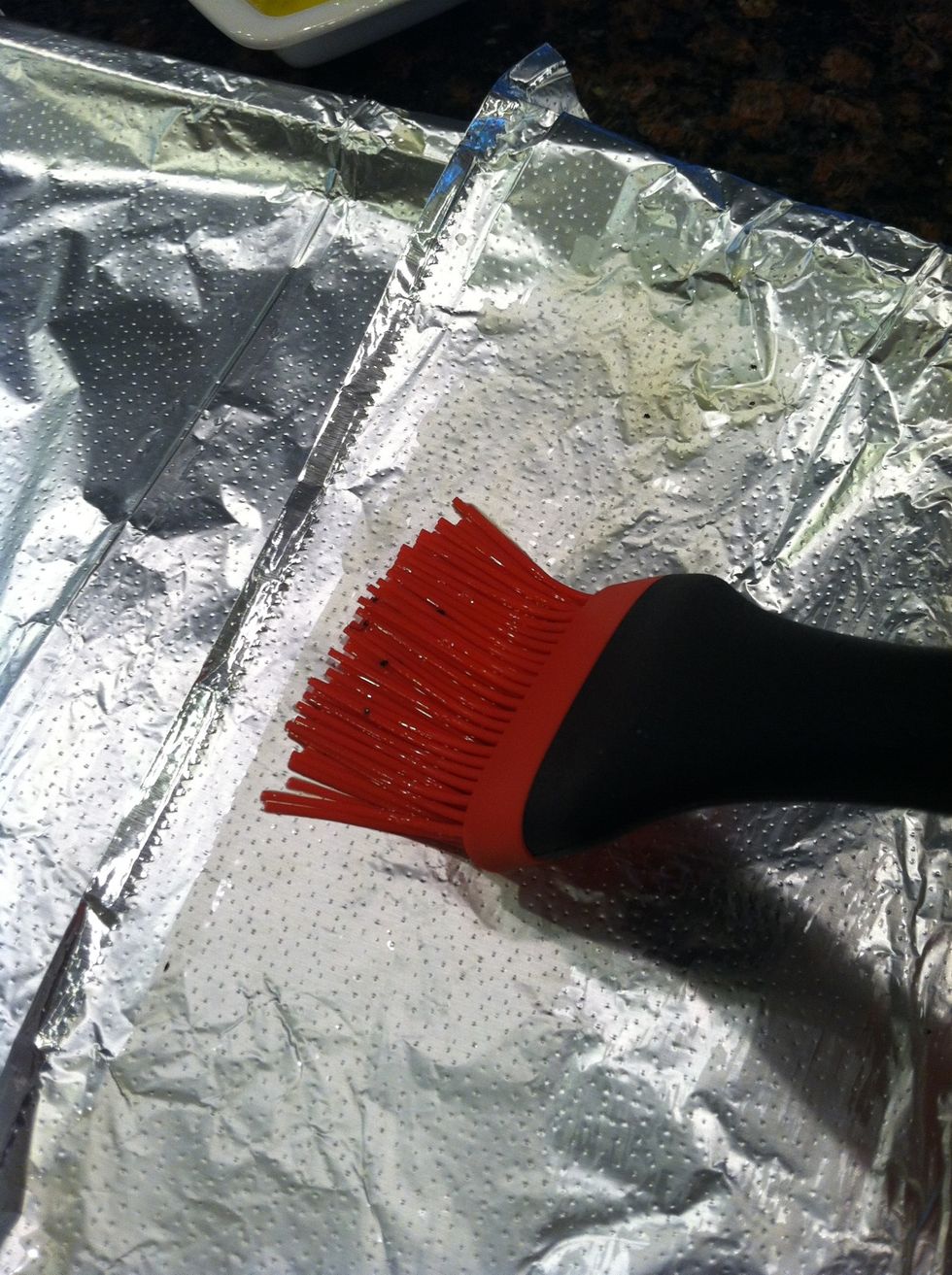 Dip your basting brush into the butter/oil mixture and lightly grease a foil-lined baking sheet.